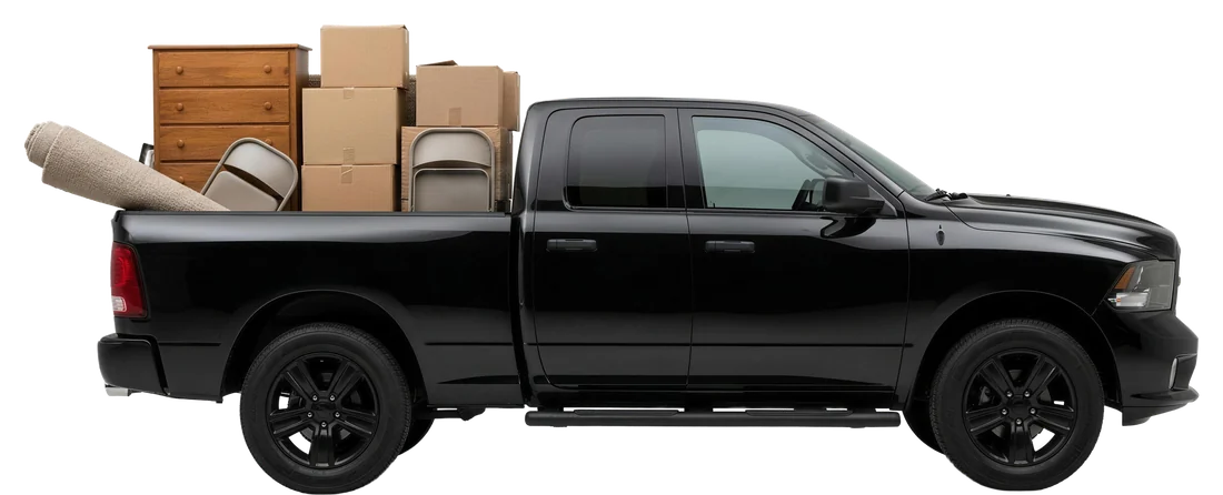 Eddy's black Ram pickup loaded with a dresser, boxes, chairs and a rolled carpet from a cleanout