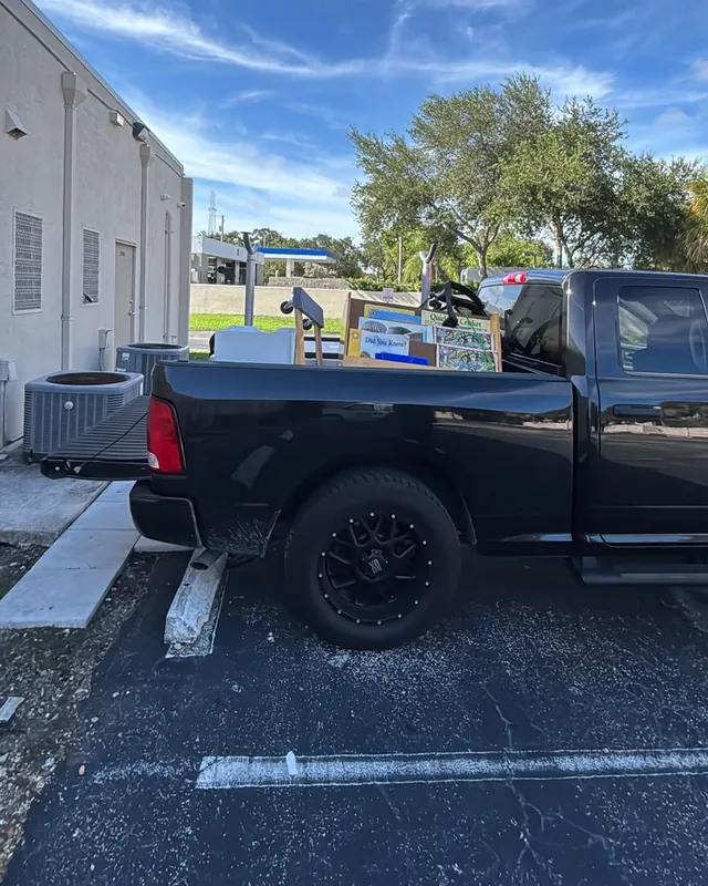 The pickup bed filled with boxes, books and office material ready to haul